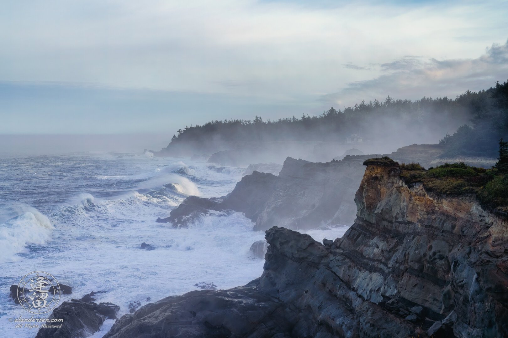 Morning light falls on the rugged Oregon coast near Shore Acres State Park. Mist clings to the coastline as angry waves roll in from the Pacific, row after row, their tops lit by the morning sun and whipped into spray by the wind, before crashing thunderously into the rocky cliffs that line this part of the coast.