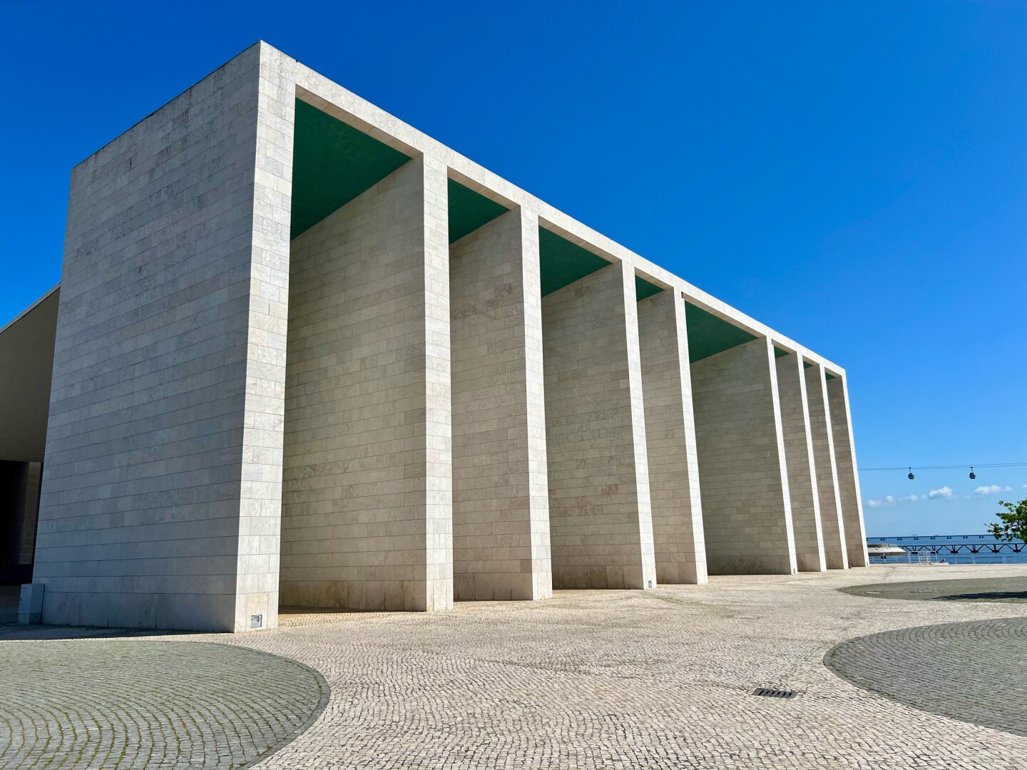 White stone building in front if blue sky.