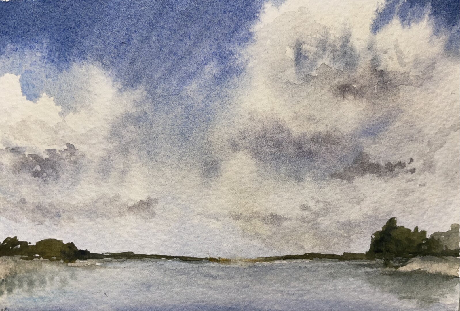 This watercolor painting depicts a lakeside scene with a vast sky filled with billowing clouds, soft blue hues, and a distant shoreline lined with trees.