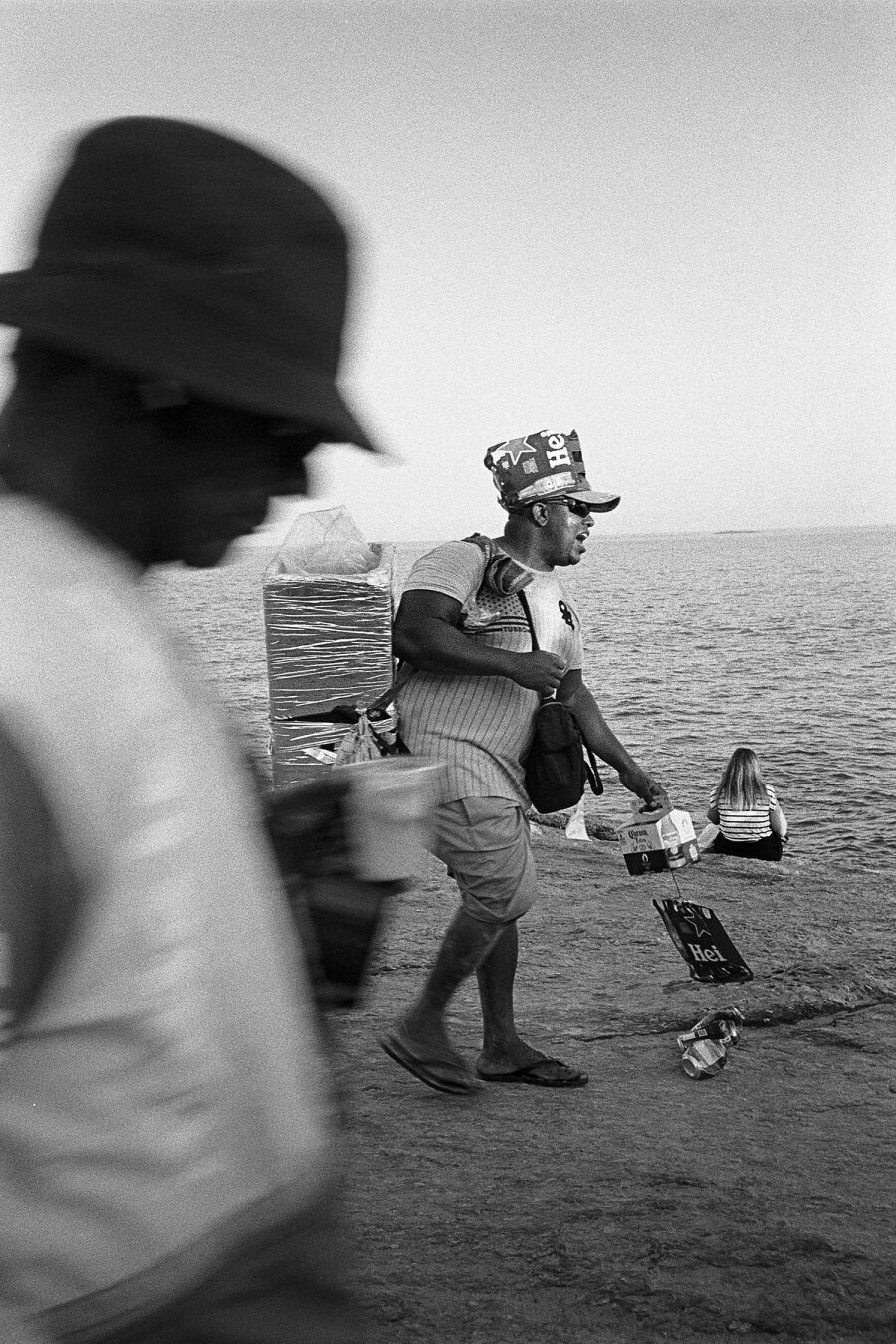 Pedra do Arpoador, rio. Picture of guy selling beer on rocks by Ipanema.