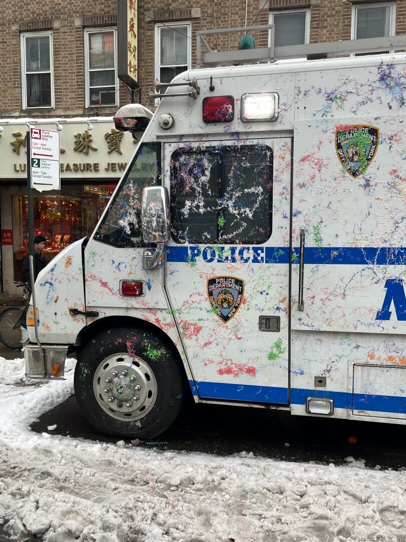 Chinese NY Parade. NYPD van covered in silly string