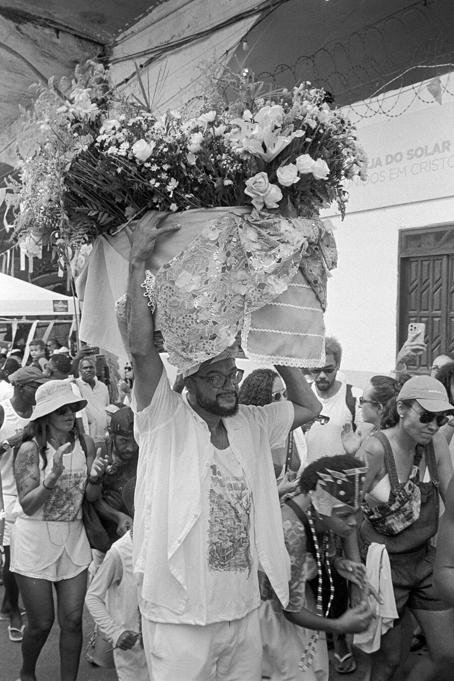 candomble priest carrying flowers in yemenja celebration