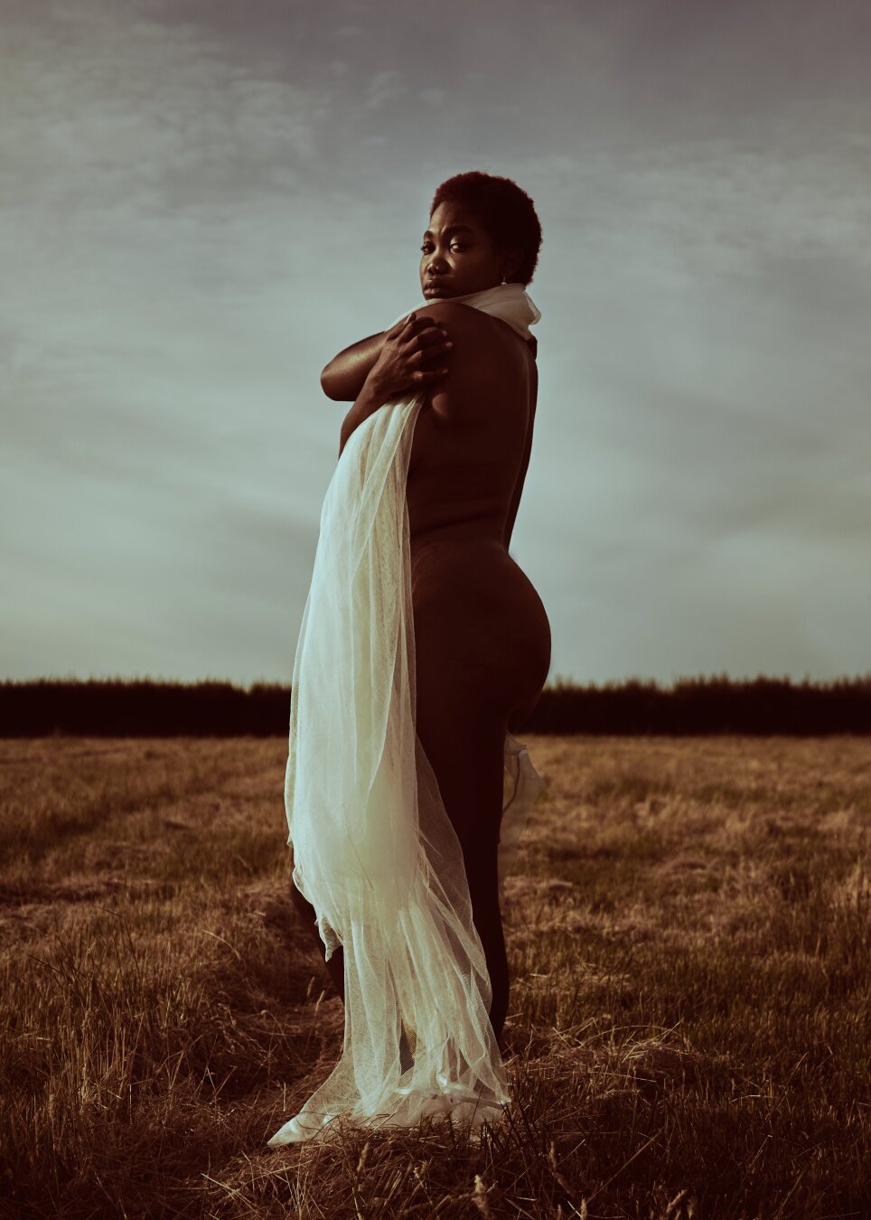 Editorial Style shot, model standing in an open field