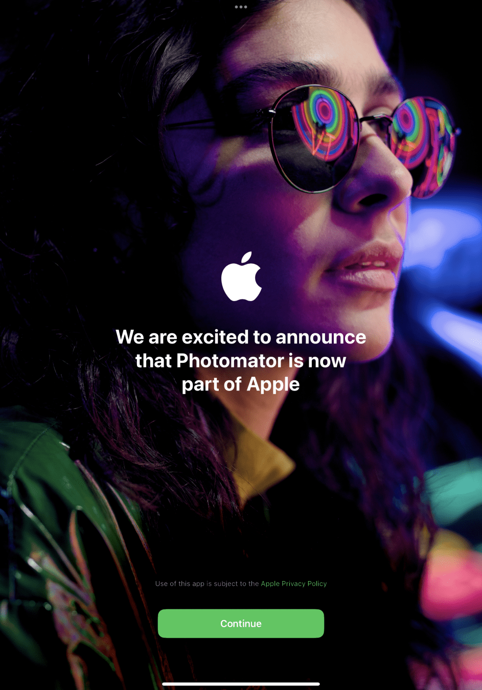 A person wearing reflective sunglasses and colorful lighting is featured in an Apple-themed announcement for Photomator joining Apple.