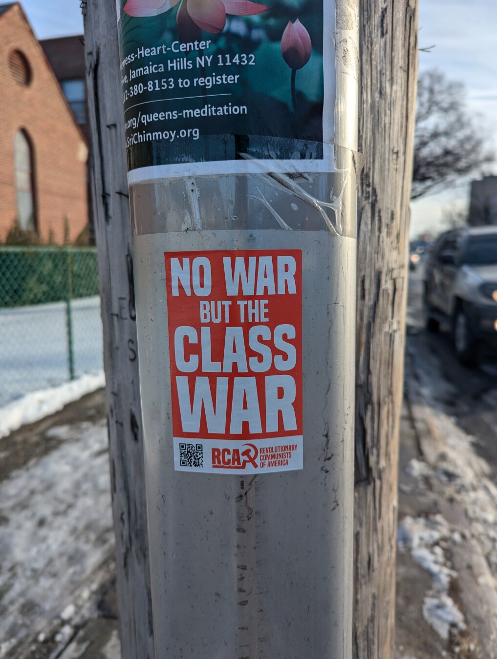 Flyer stuck onto a power pole with a red background and white all caps text:

NO WAR
BUT THE 
CLASS
WAR