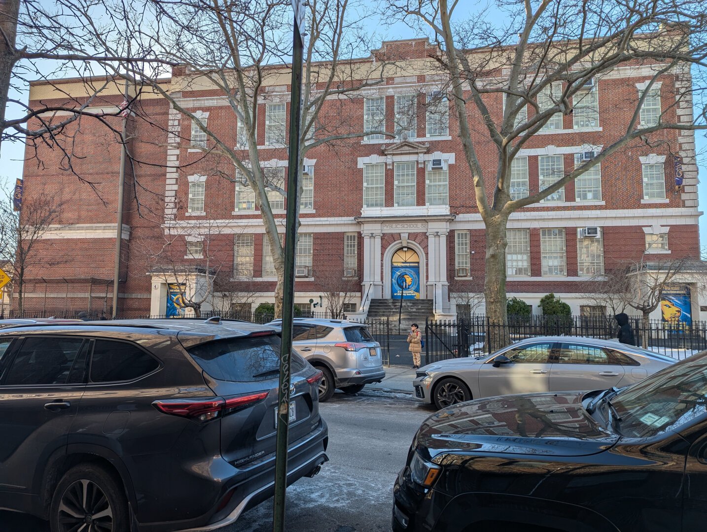 Three story brick school building.