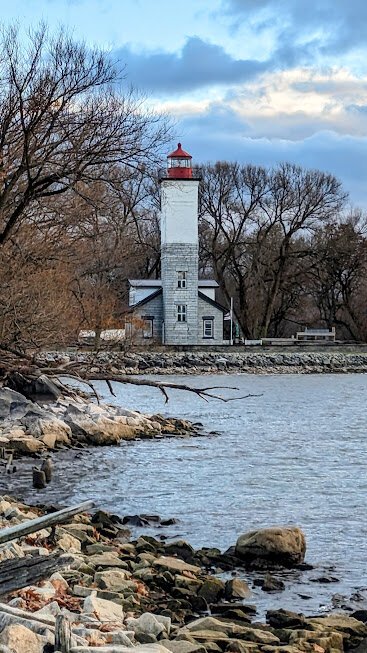 Looking down a rocky shore to a lighthouse