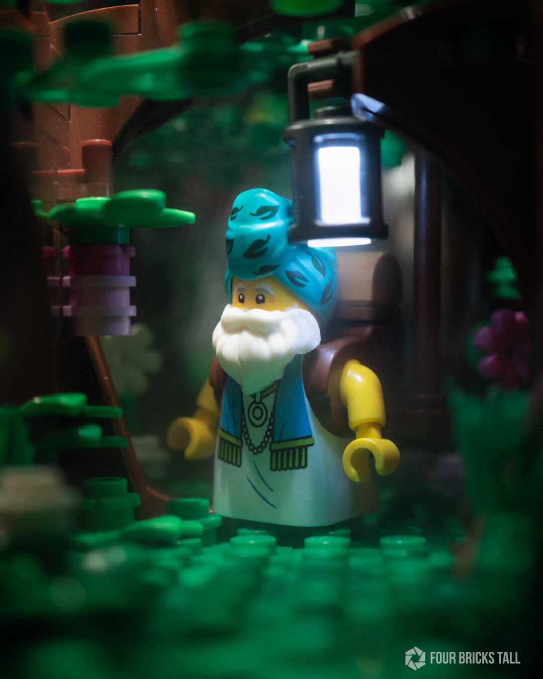 LEGO wizard in a forest looking at a flower