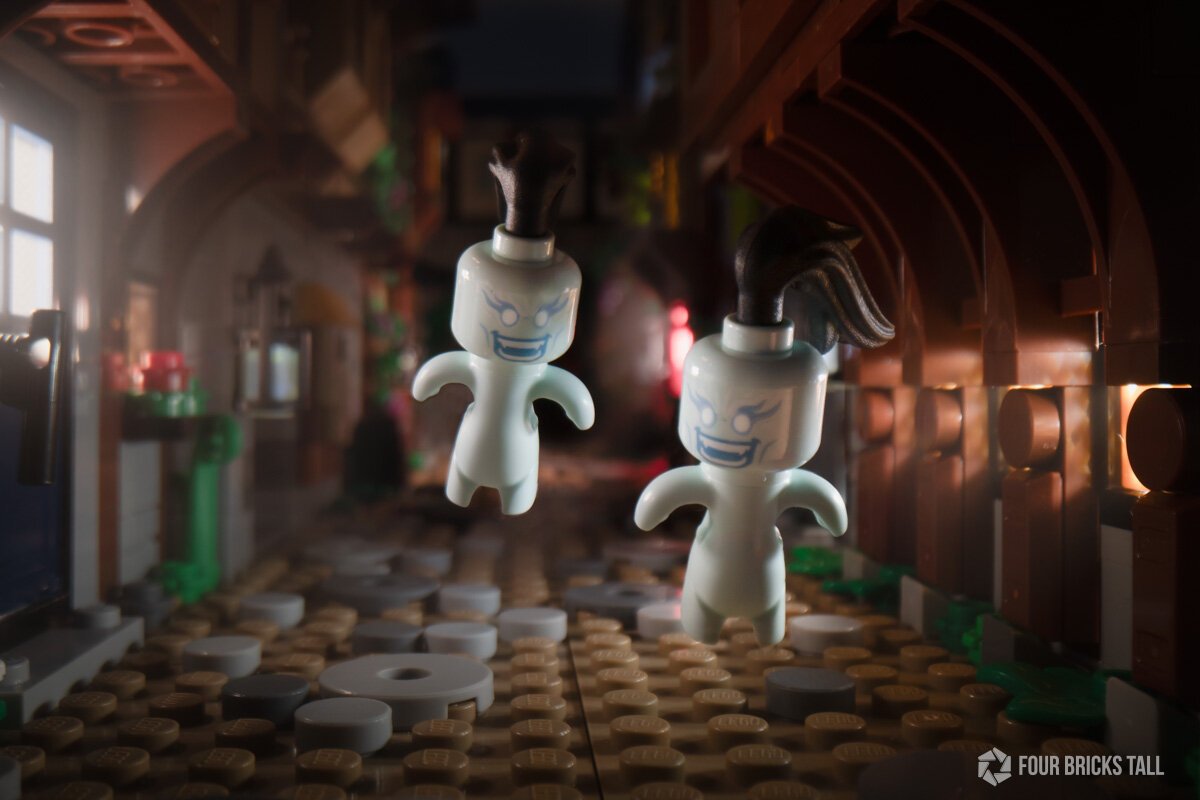 Two ghoulish LEGO minifigures with small bodies flying through a dark medieval street