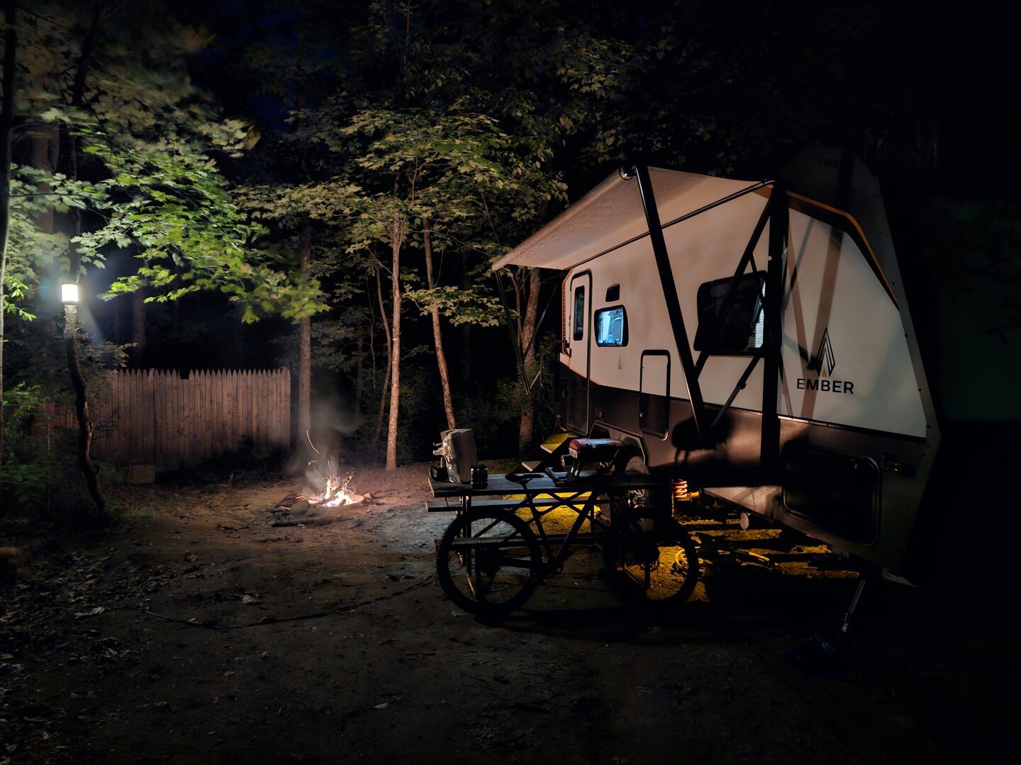 Low light capture of a travel trailer next to a fire