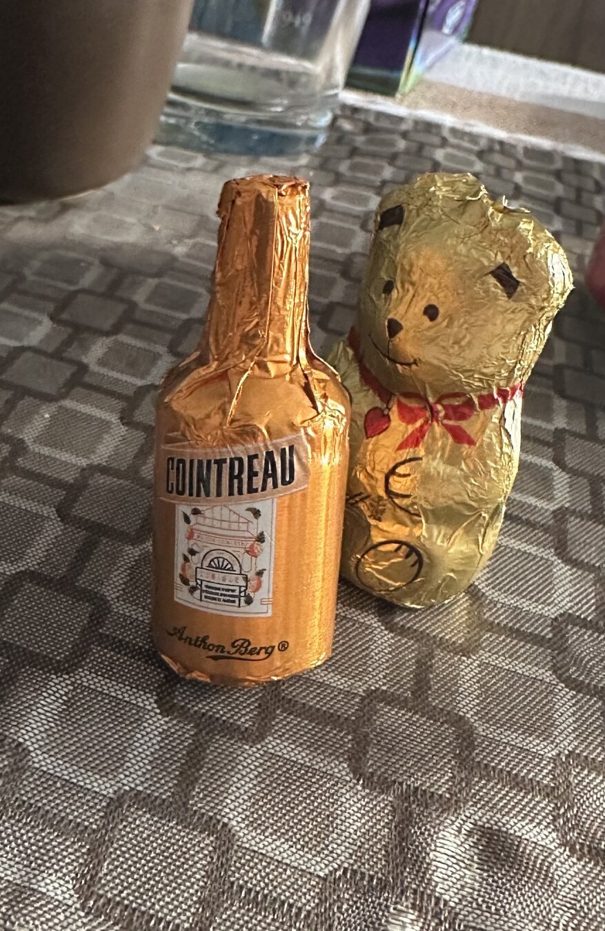 a little chocolate bear with a chocolate liquor bottle