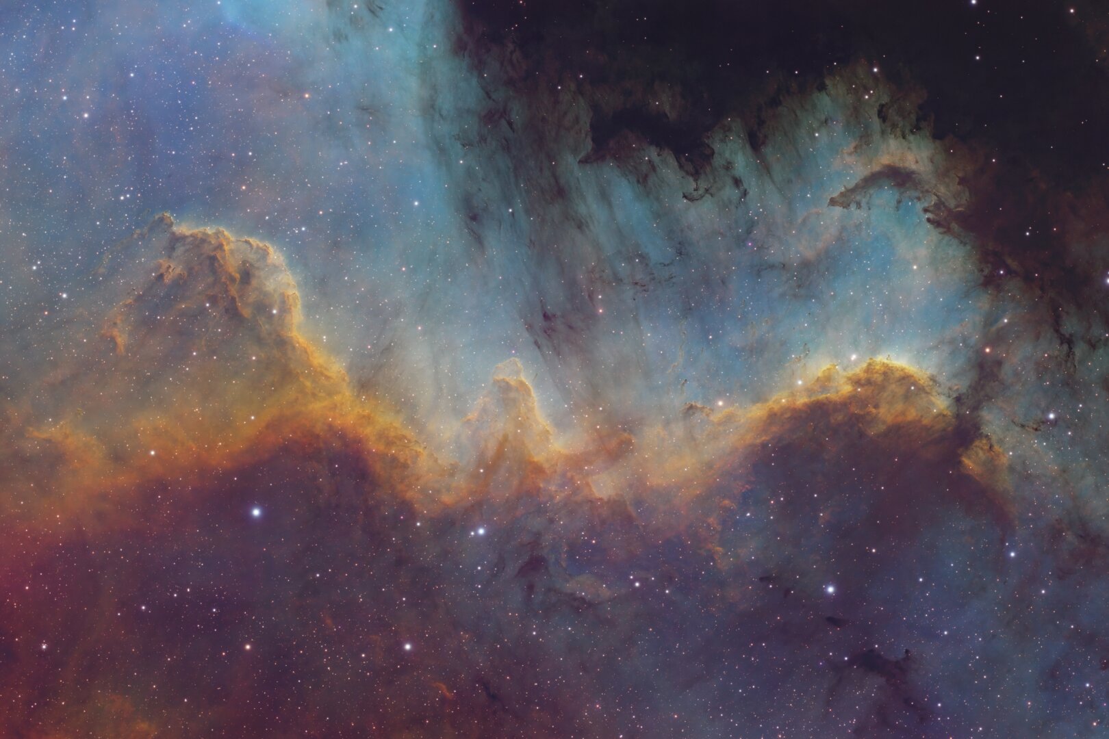 A huge structure of rainbow-colored interstellar gas that looks a lot like a mountain range
