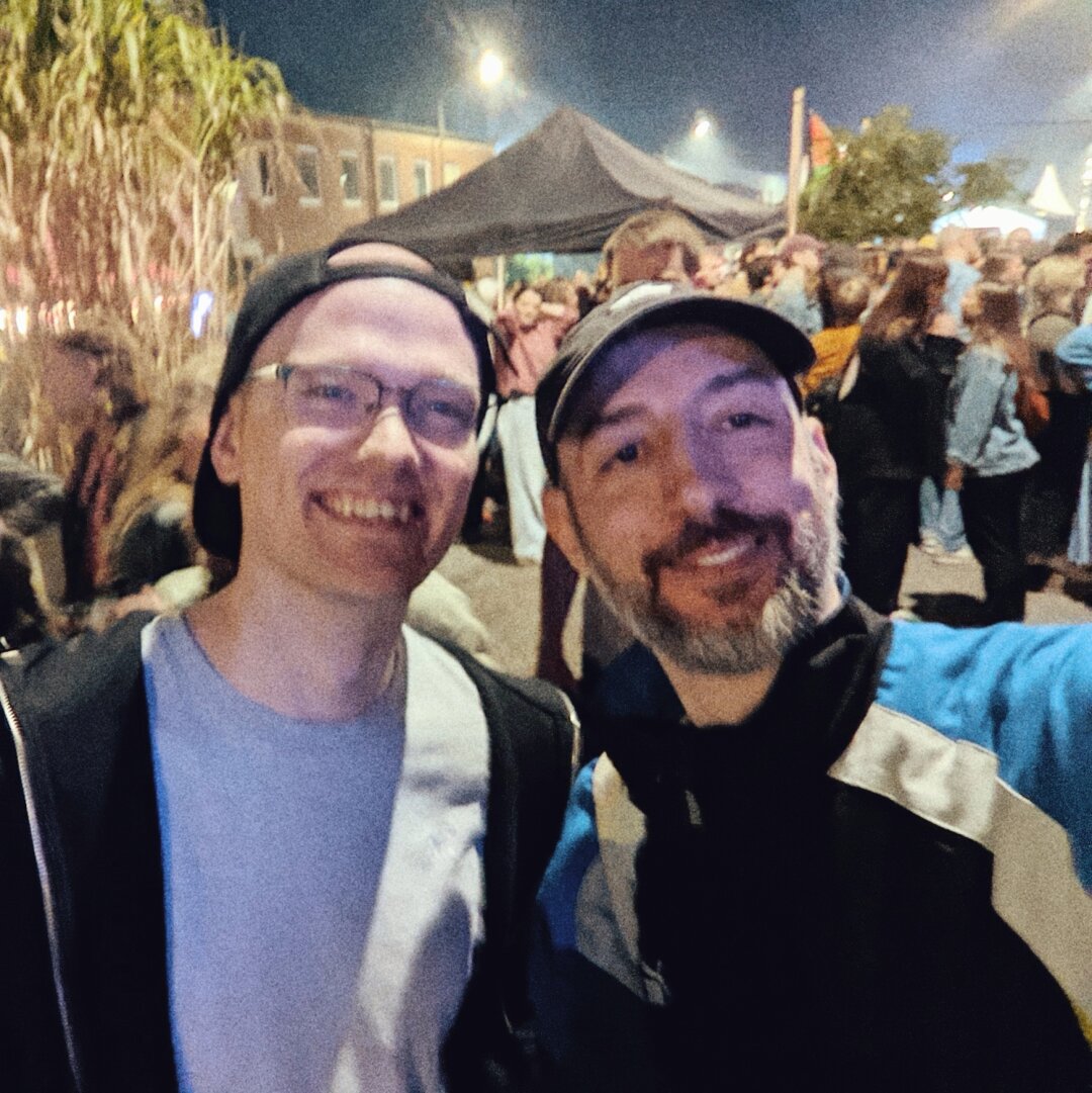 Two people smiling at a festival