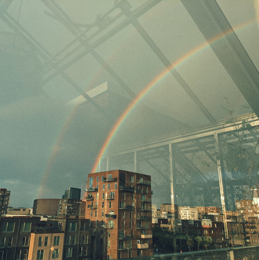 A view of a double rainbow through a window