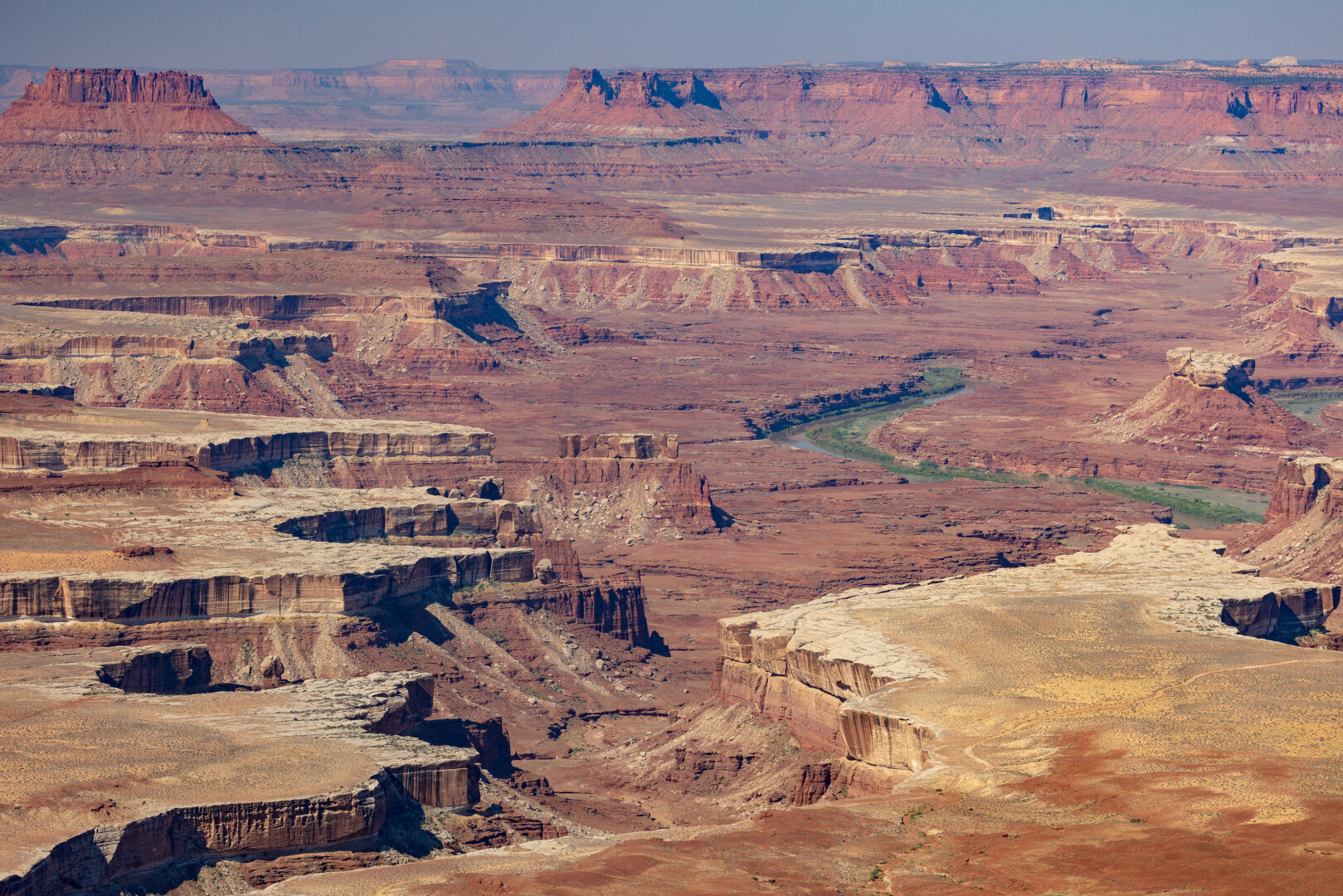 Red sandstone canyons carved by a sinuous Green River.