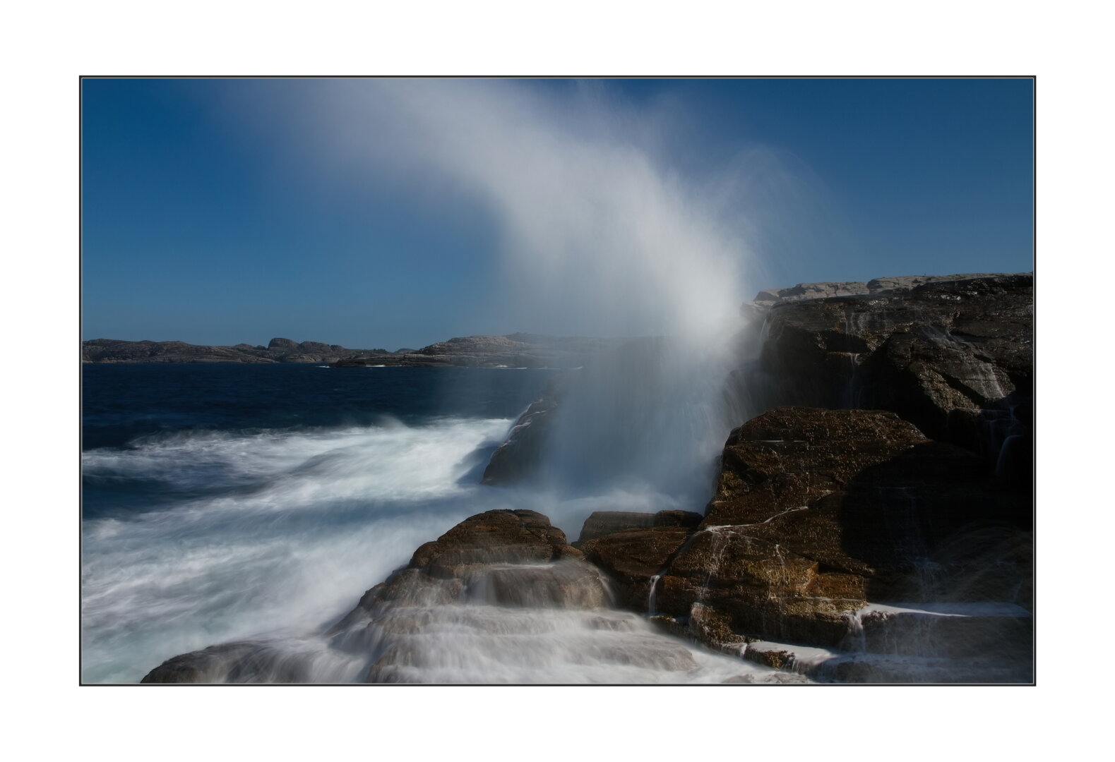 waves splash on the rocks.