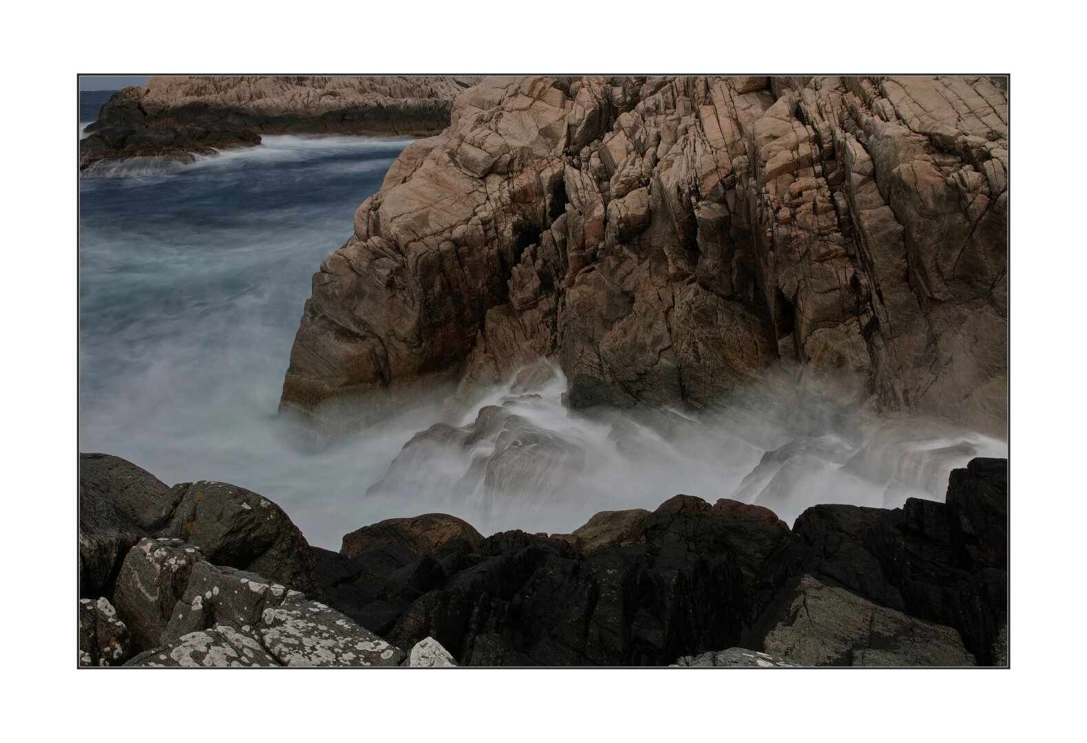 Stones under waves. Long exposure. Colour.