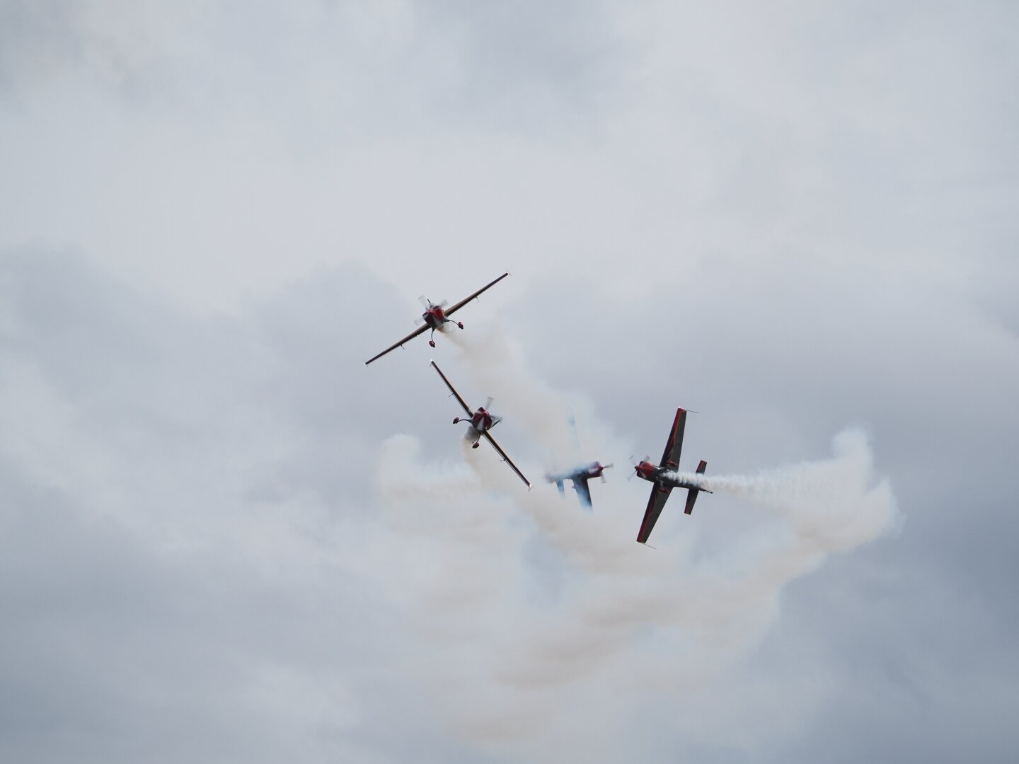 Four Royal Jordanian Falcons aircraft performing a break maneuver