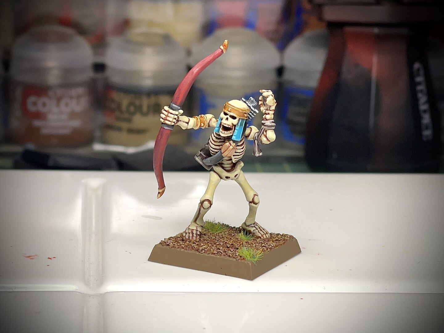 Single painted Tomb Kings skeleton archer with teal headdress and red bow