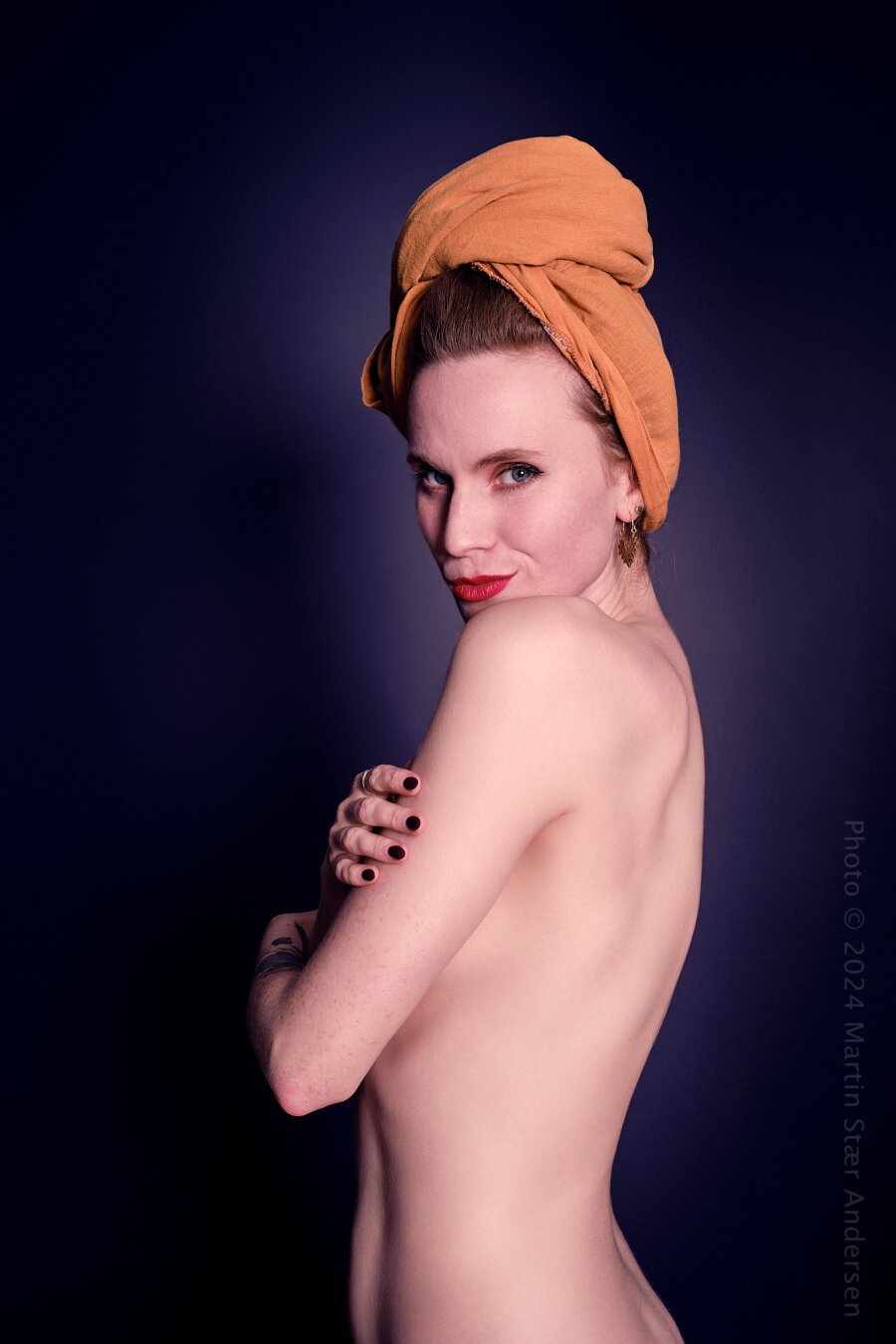 Art nude model with an orange head dress