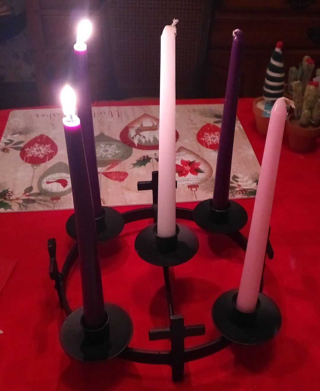 Wrought iron Advent wreath with two candles lit.