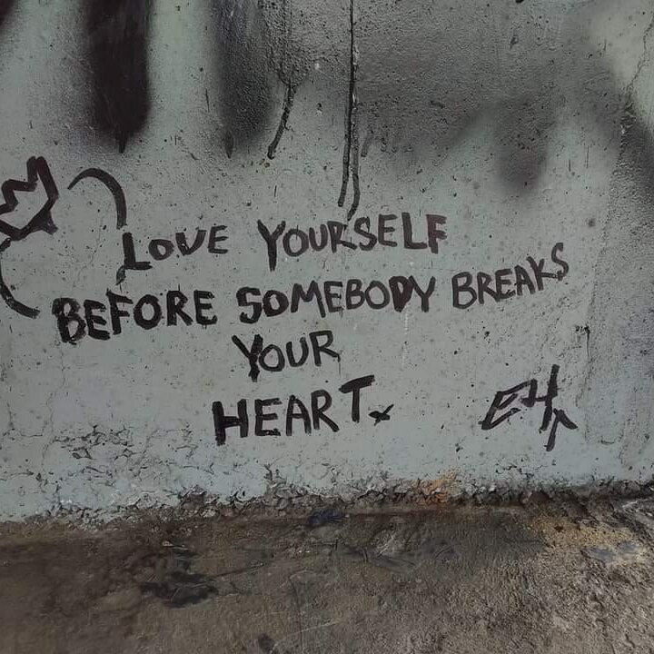 Grafiti on a bridge pillar. Reads" Love yourself before someone breaks your heart."