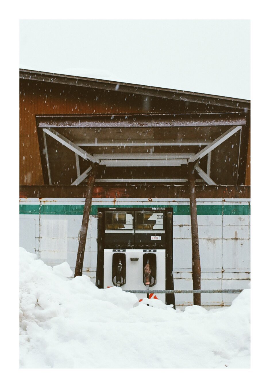 A gas pump deep in snow.