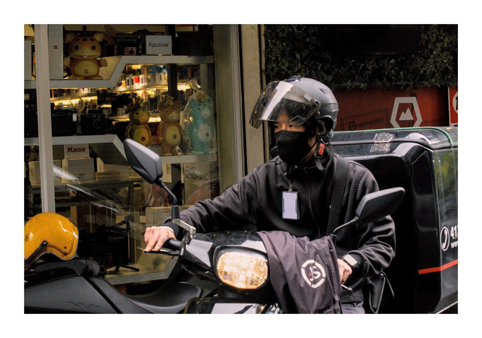 A man on a scooter with a reflective helmet