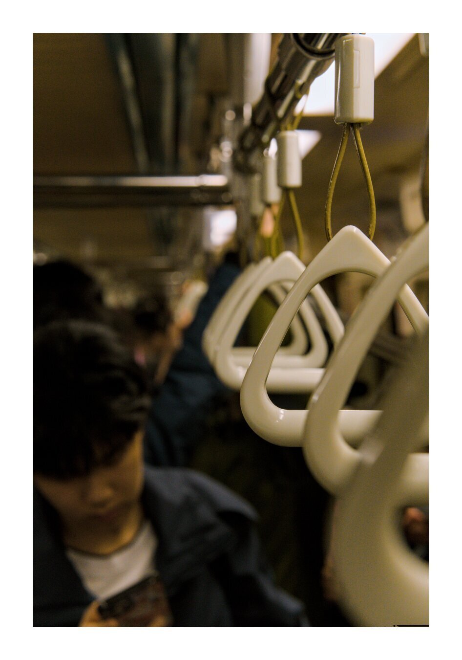 a man on the subway playing on his phone