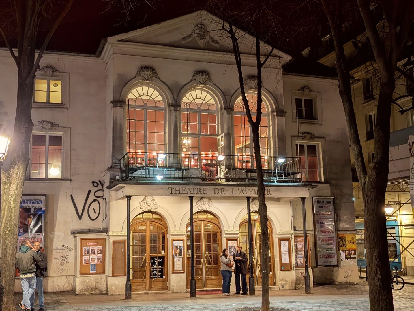 A theater, at night.