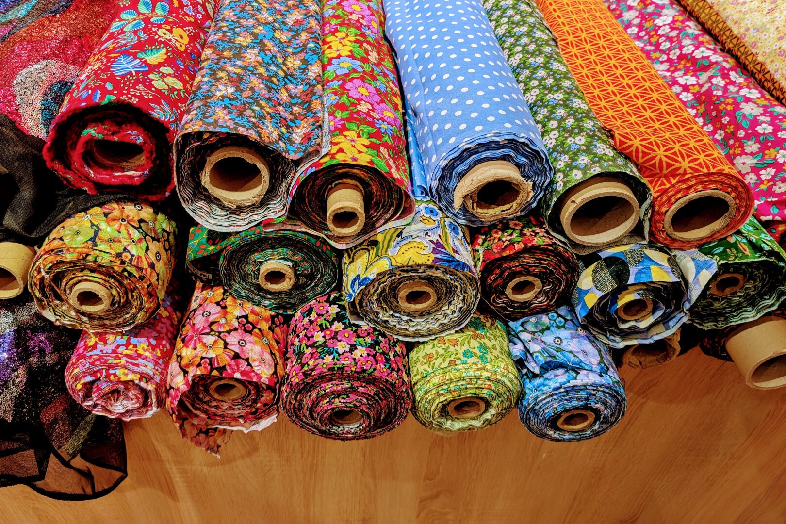 Rolls of colored fabric with various patterns