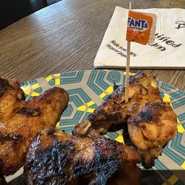 A plate of chicken wings at Nando’s. The flag shows its Fanta flavour.