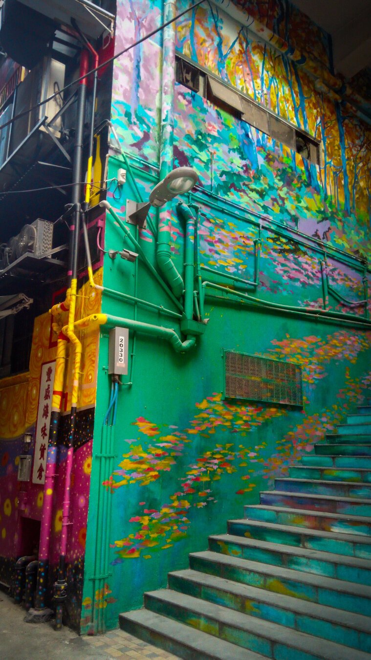 An alleyway that is painted in colourful art.