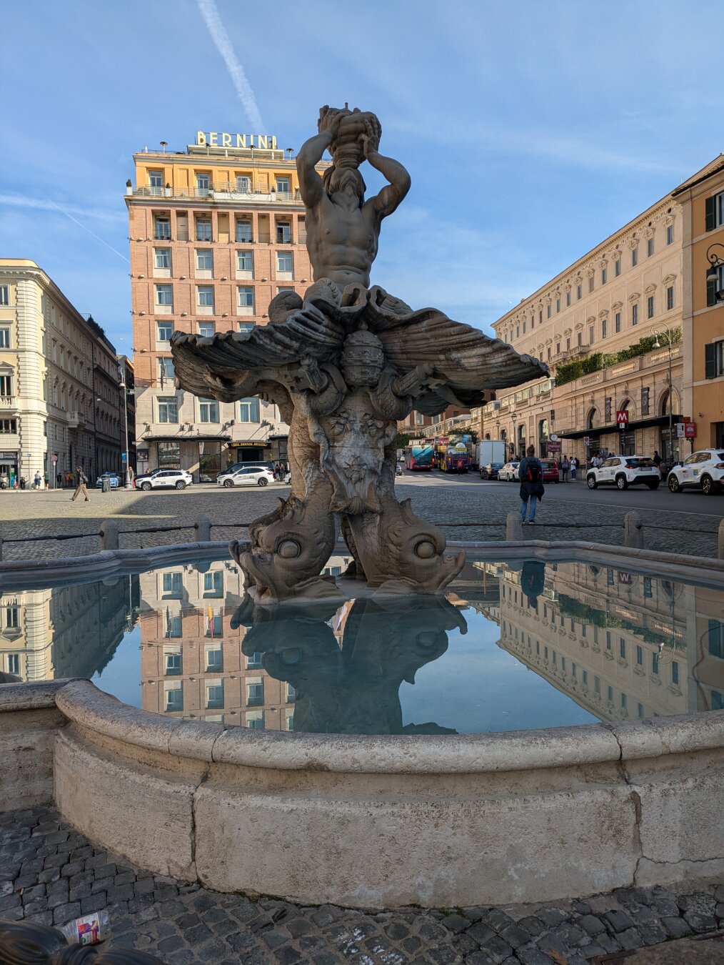 A fountain with buildings in the background