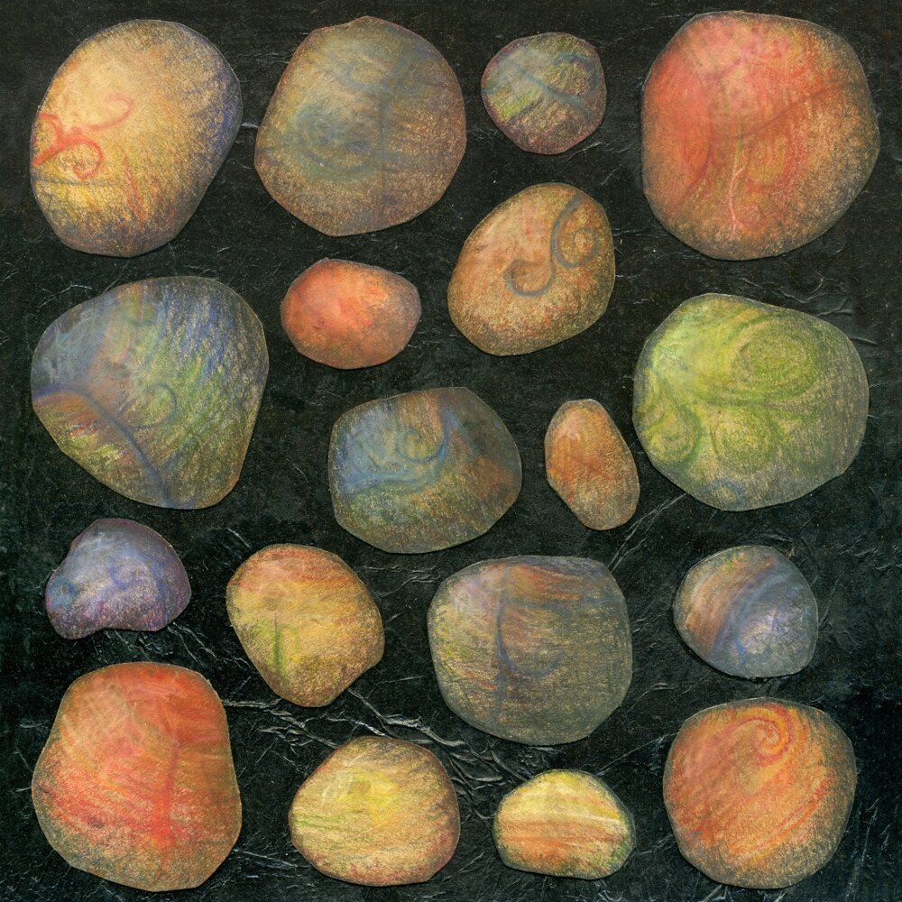 Collage with multicoloured pebbles in pastel, on a black textured background made from glued tissue paper