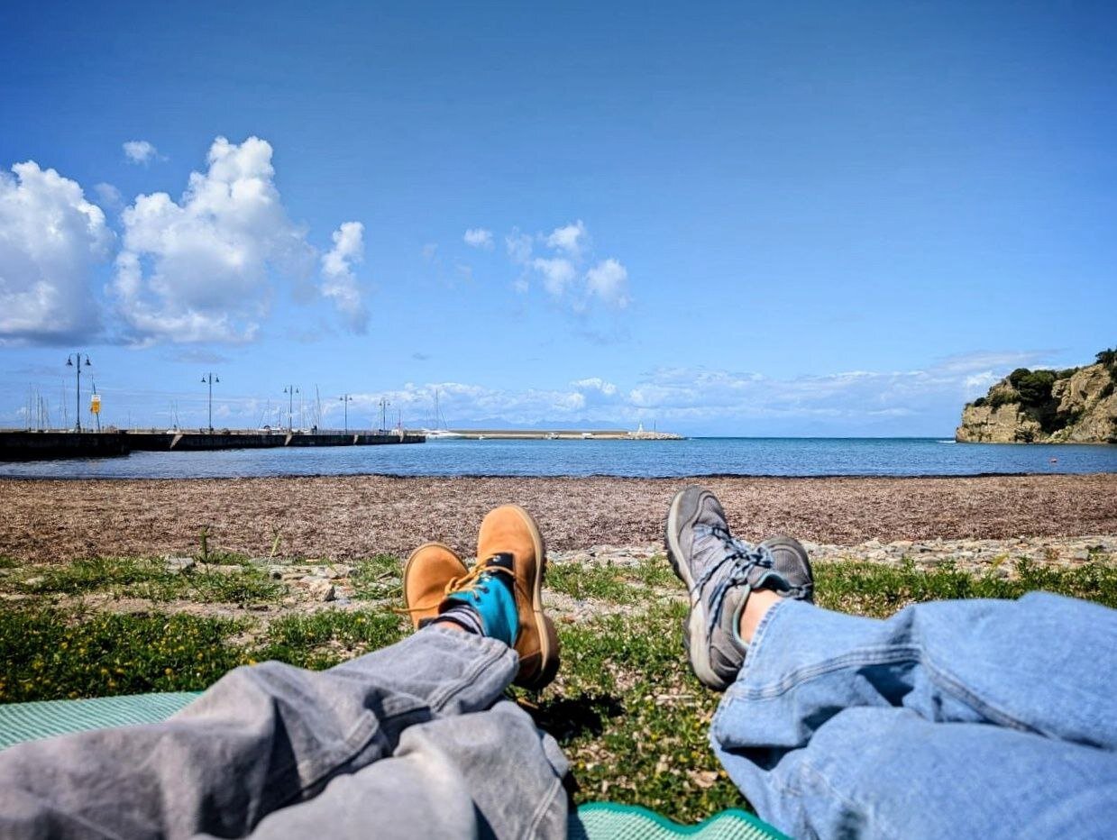 My partner and I taking a break after an unplanned seaside picnic.