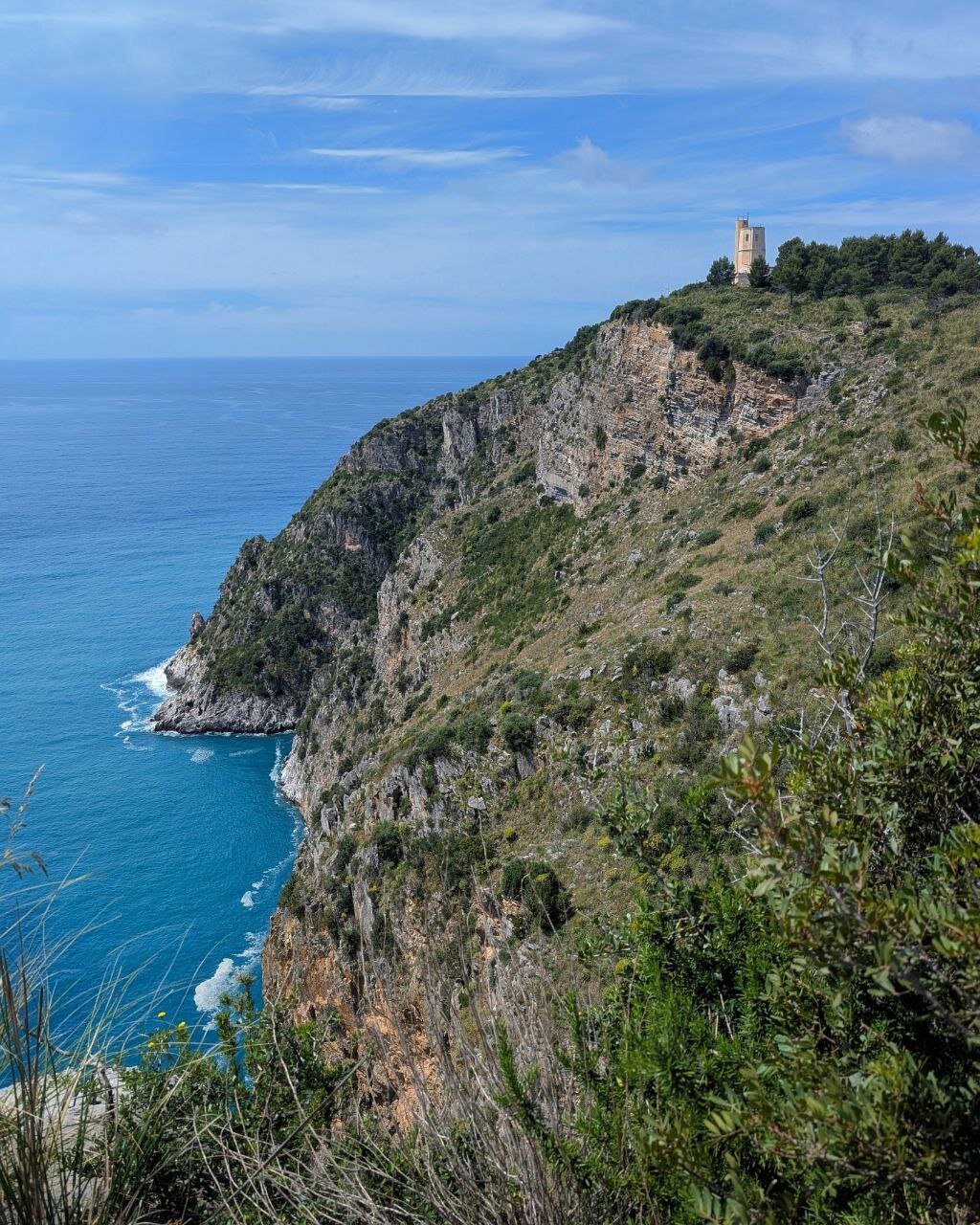 View of the promontory on which the lighthouse of Capo Palinuro stands, from a scenic viewpoint above Cala Fetente.