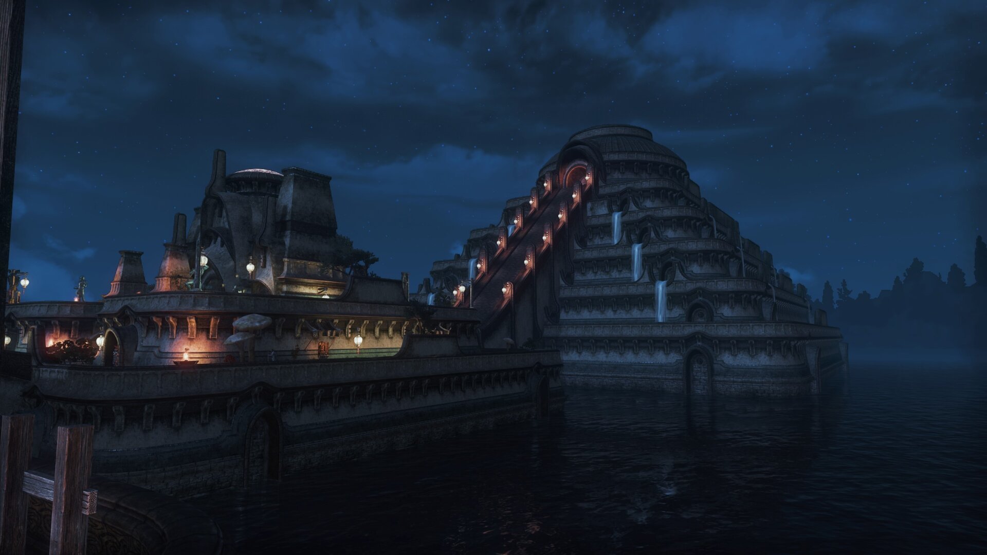 A screenshot from the game Elder Scrolls Online. It depicts Vivec's Temple and the Temple Canon, a part of Vivec City, at night. The impressive buildings are built into the sea. The atmosphere is calm and the buildings are illuminated beautifully. The sky is slightly overcast, but the stars are visible.