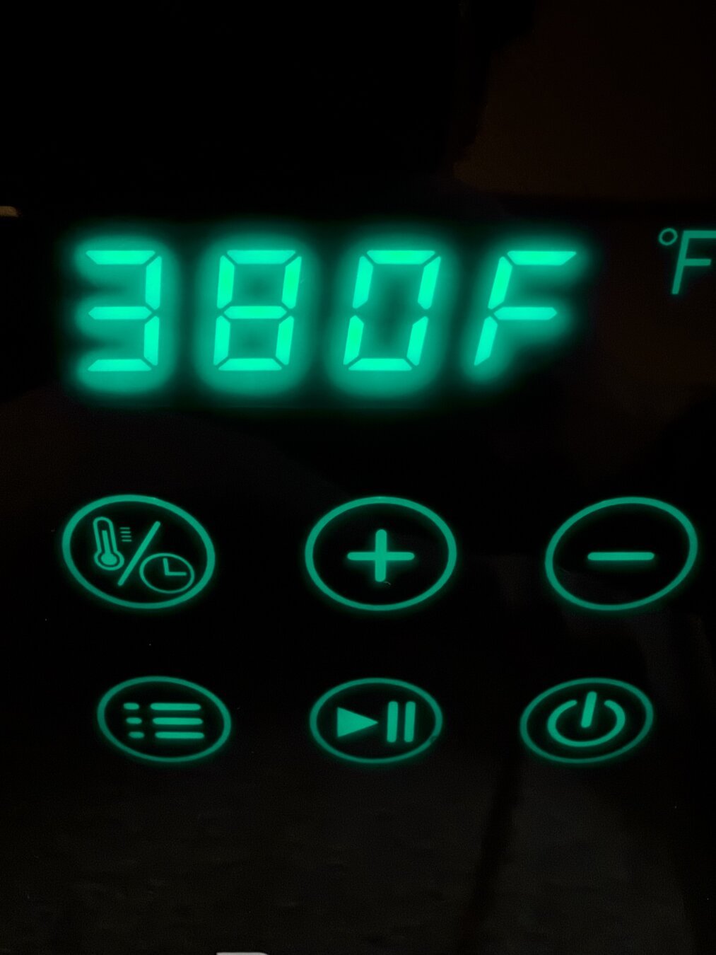 Digital display of air fryer controls. The letters are green.