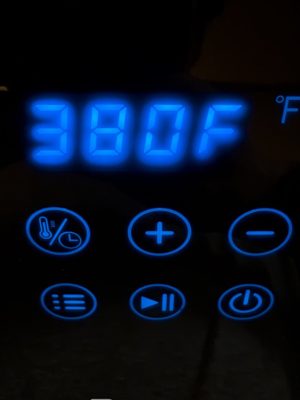 Blue and black touch controller of an air fryer. The temperature is set to 380 degrees.