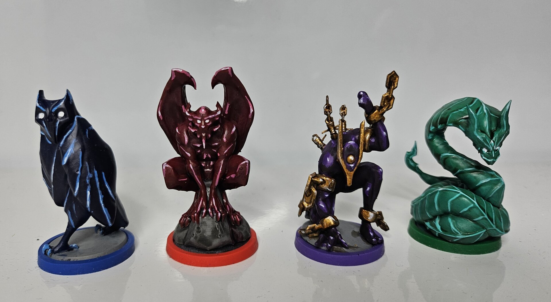 Four guardians painted. From left to right: dark blue owl with light blue and white highlights and white eyes. Dark red winged demon with white highlights and white eyes. A purple golem thingy wearing golden chains. A jade green snake with white highlights and white eyes.