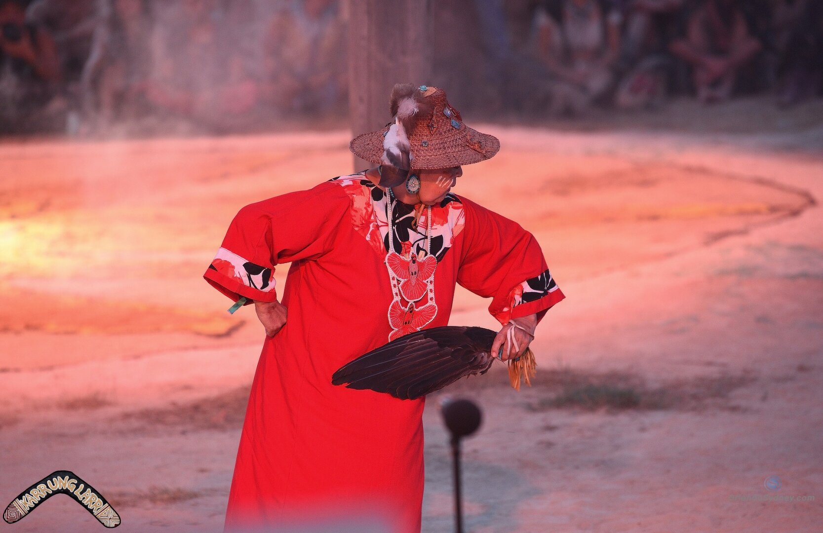 Indigenous Elder Aunti Mali Dancing.  With Red Regalia on and Eagle Fan