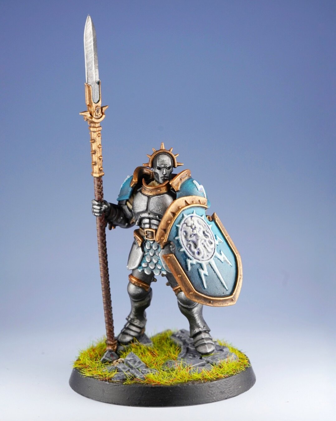 Picture of a painted miniature of the game Warhammer Age of Sigmar. Is a person in full armor, with a lance and a shield, from the front.