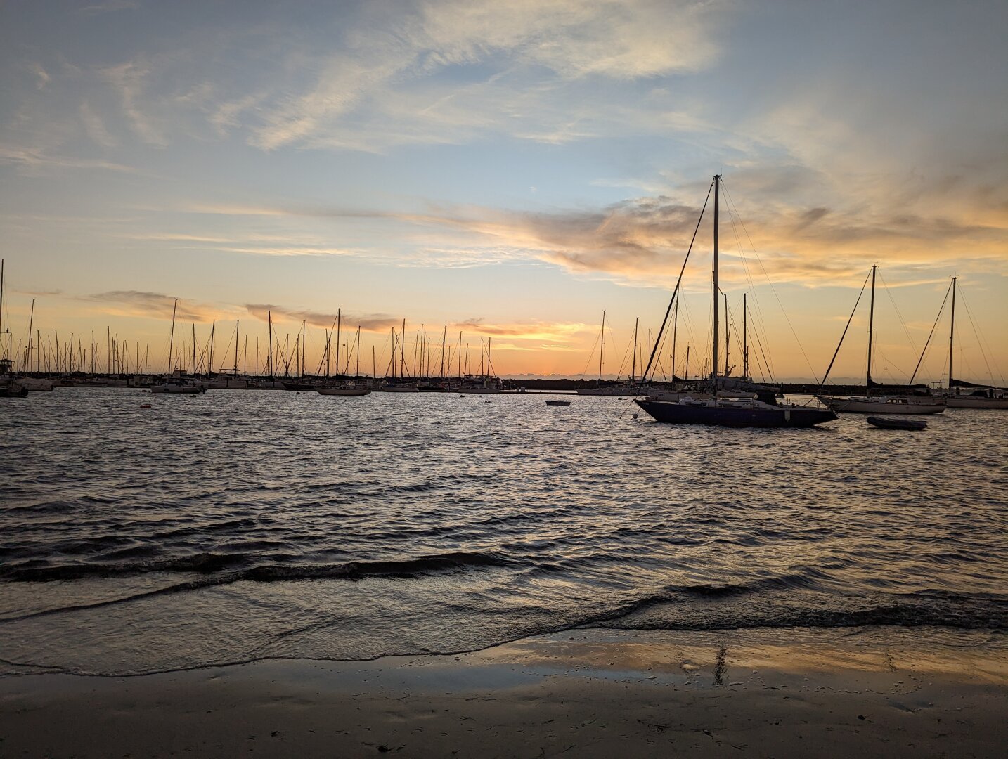 Sunset sky from st Kilda beach with moored sailing boats silhouetted in the foreground