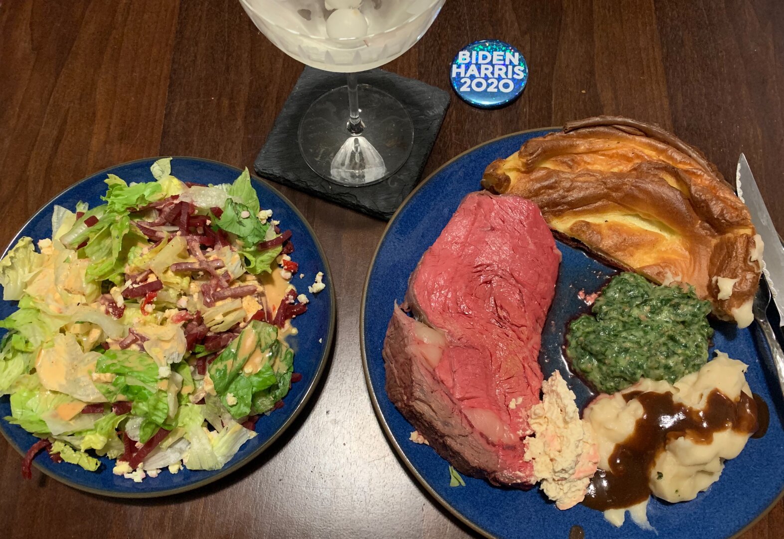 prime rib dinner with a martini and a Biden/Harris 2020 pin
