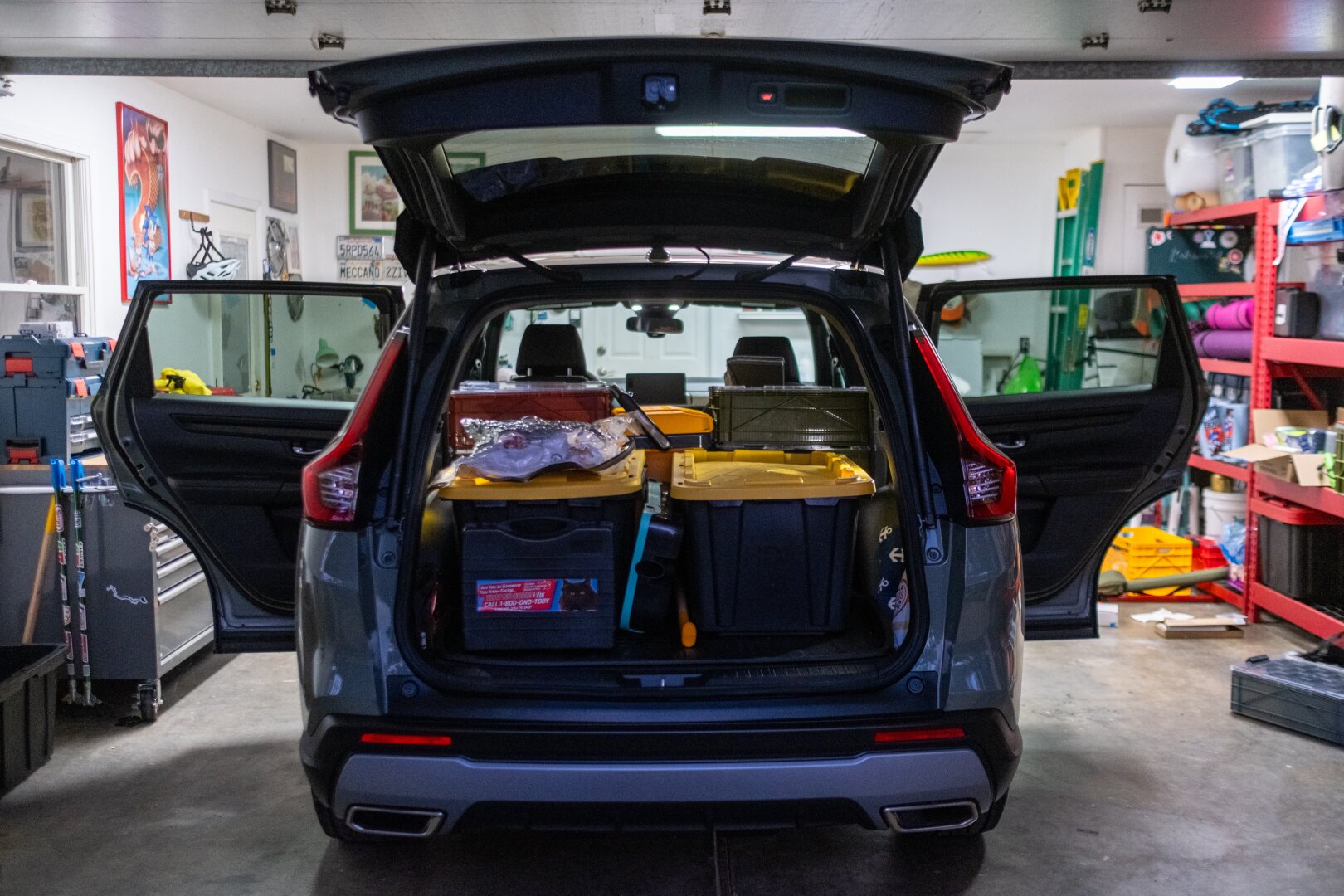 A car sits with its doors and trunk open, packed with things. [Fuji X-T5 / Fuji 23 1.4]