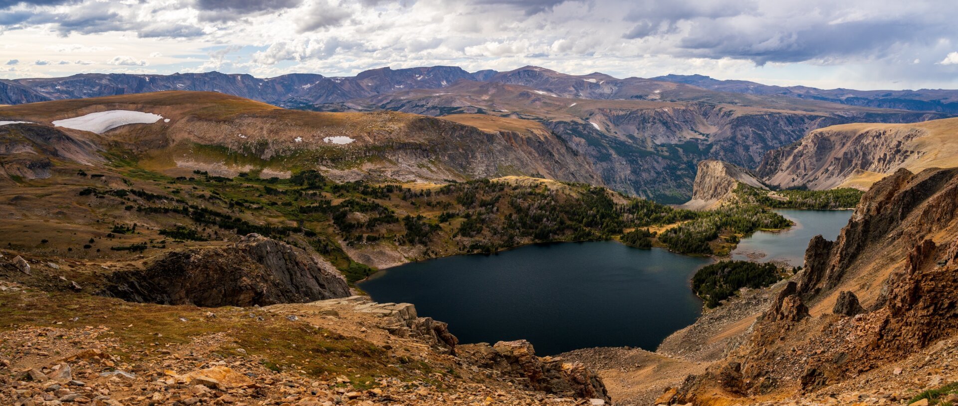 Two lakes in a rocky landscape, with valleys behind. [Sony A7R V / Tamron 25-200]