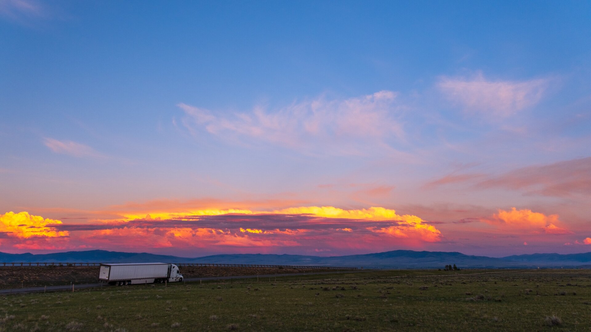 A truck sits alongside a road at sunset. [Fuji X-T5 / Tamron 18-300]