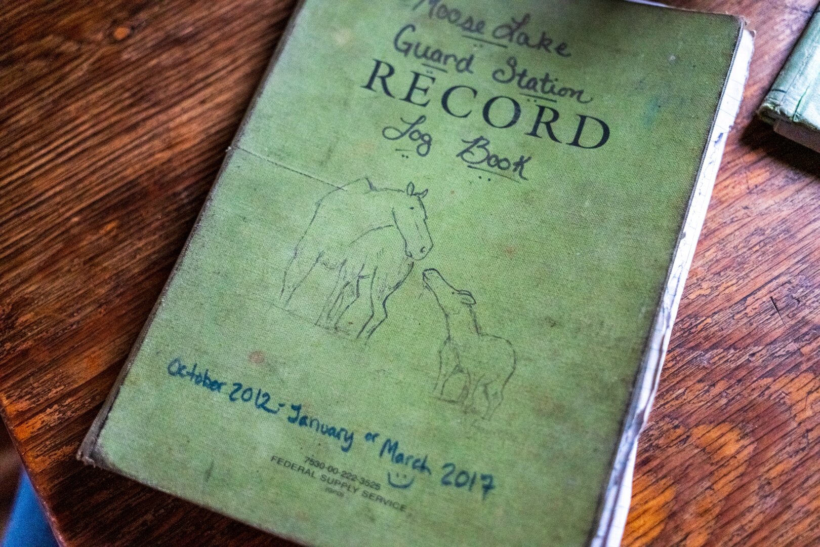 On the "Moose Lake Guard Station Record Book", two moose are drawn touching noses. [Fuji X-T5 / Sigma 17-40 1.8]