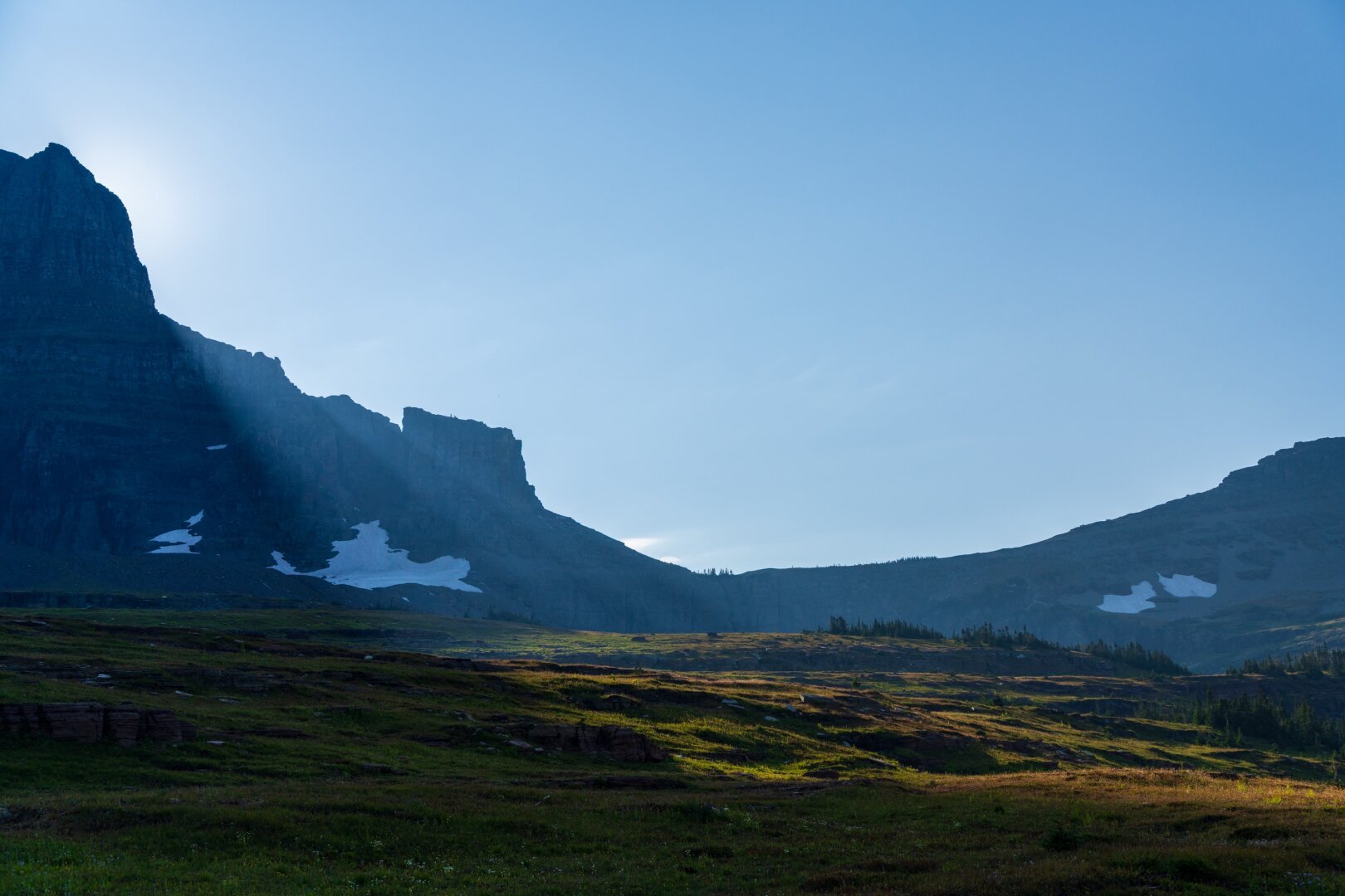 The last bit of sun hits a valley, over a mountain. [Sony A7R V / Tamron 25-200]